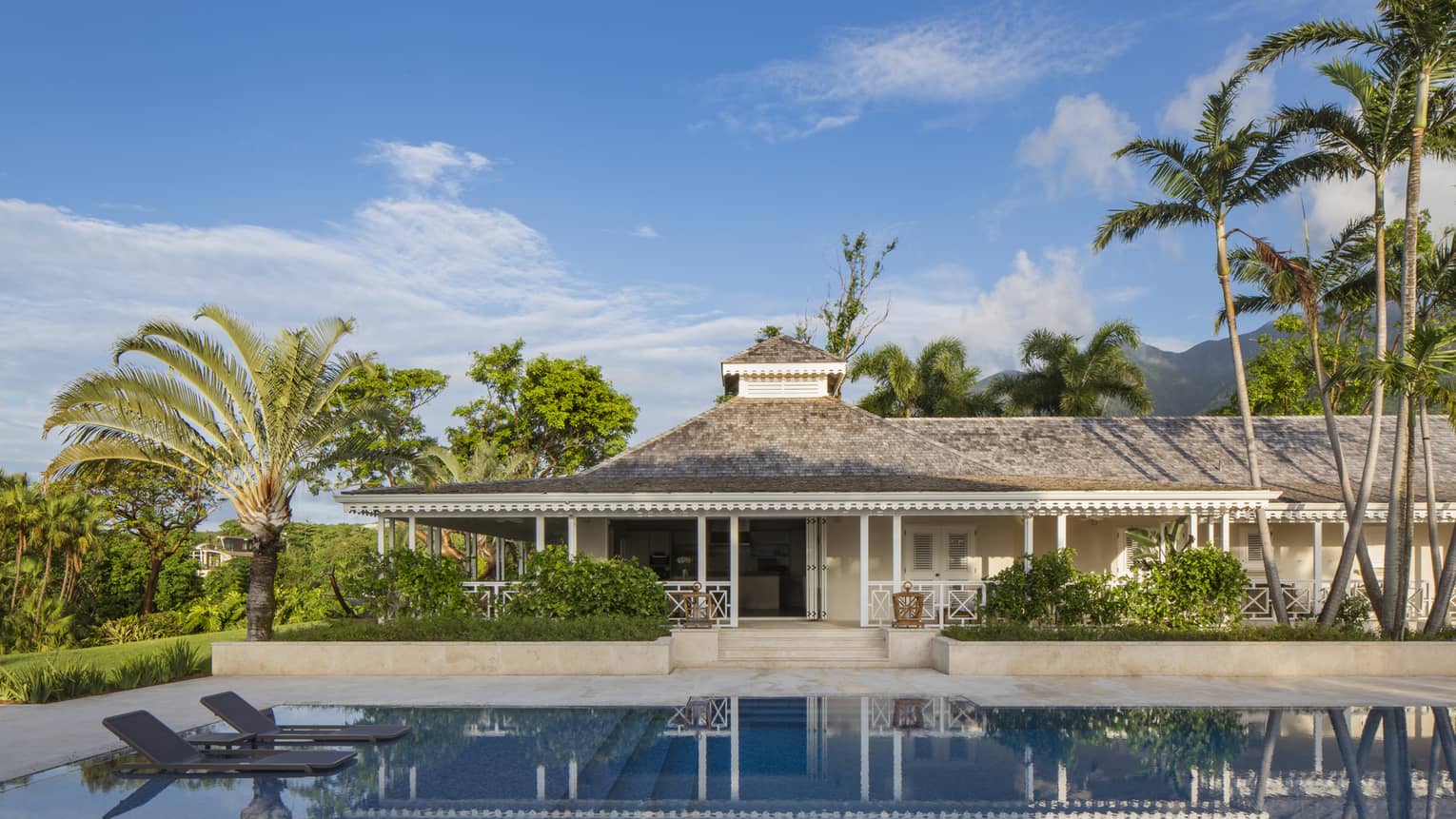 Large, private plunge swimming pool, floating lounge chairs outside Palm Grove Residence Villa