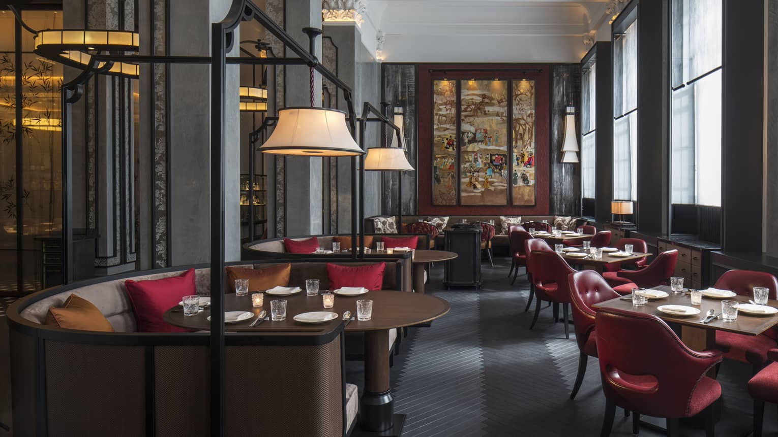Wide view of Mei Ume dining room with brown tables, red chairs and red and brown accent pillows