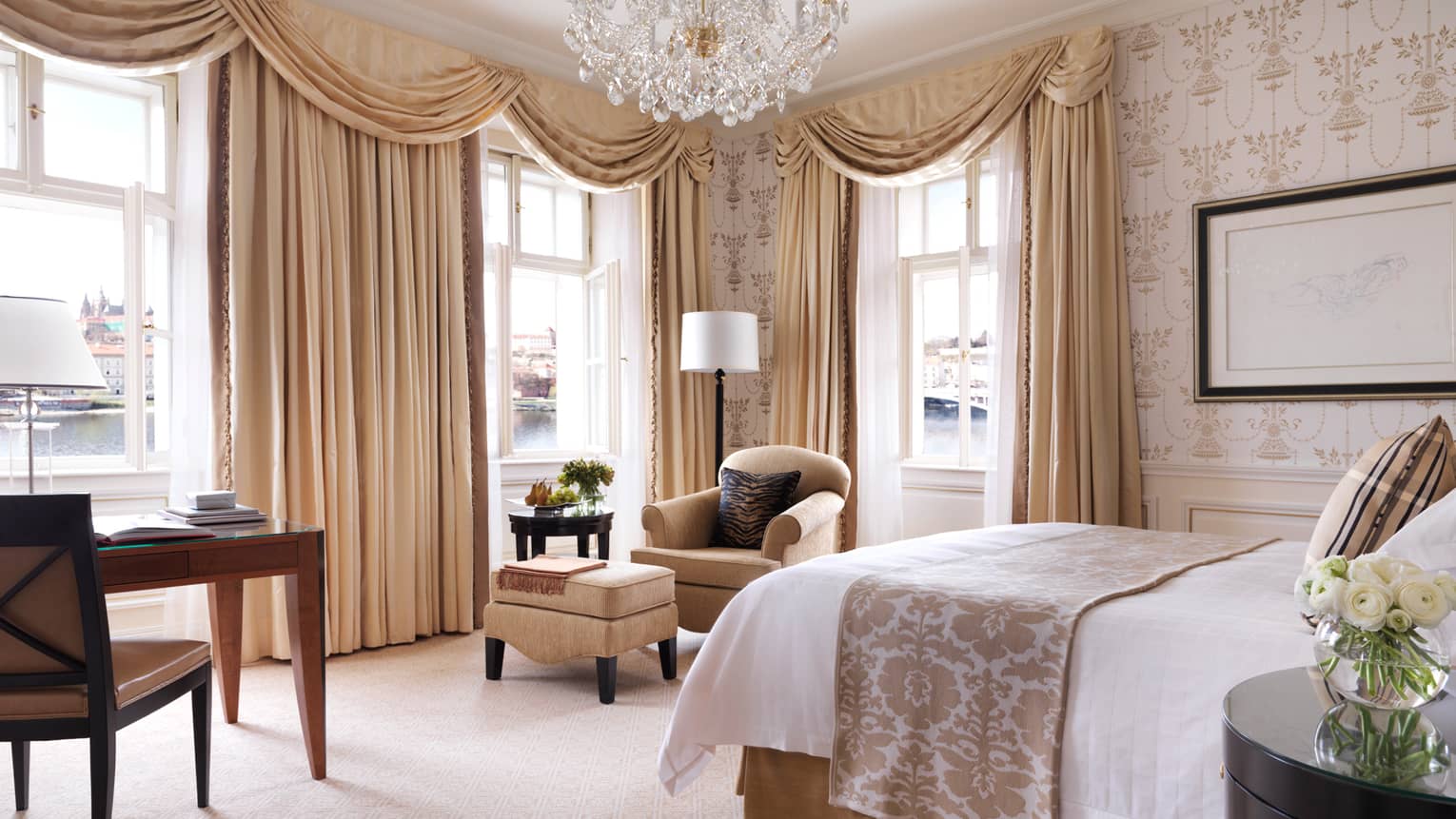 Premier Room bed, desk, chair, cream-and-gold Old European decor, long curtains, crystal chandelier