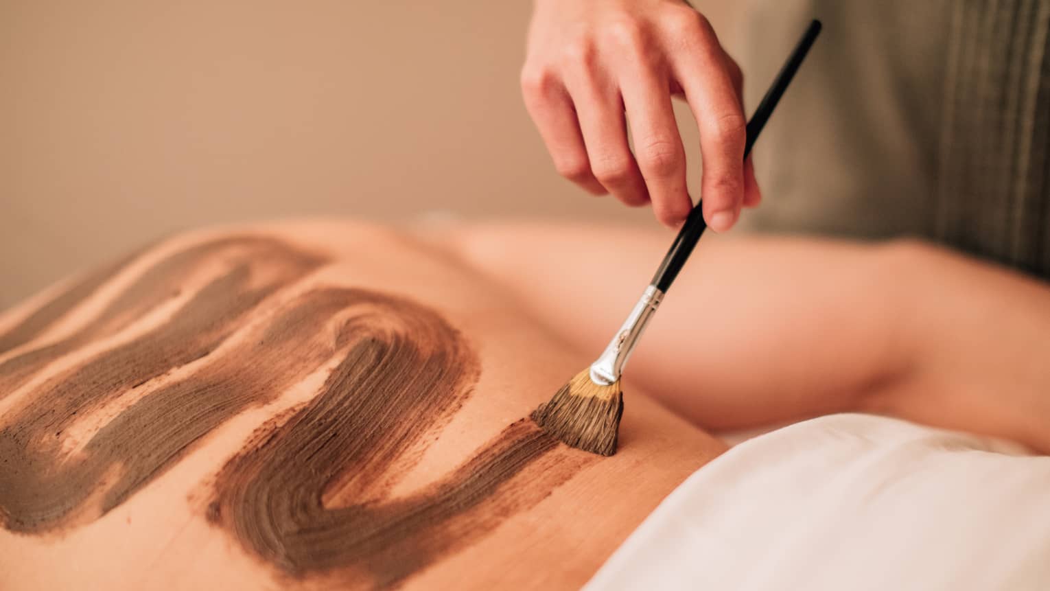 A spa treatment where nutrients are brushed and massaged into the back.