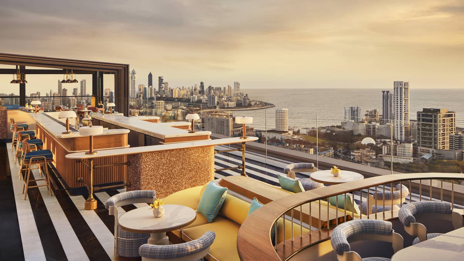 AER rooftop lounge at sunrise with views of Mumbai's skyline