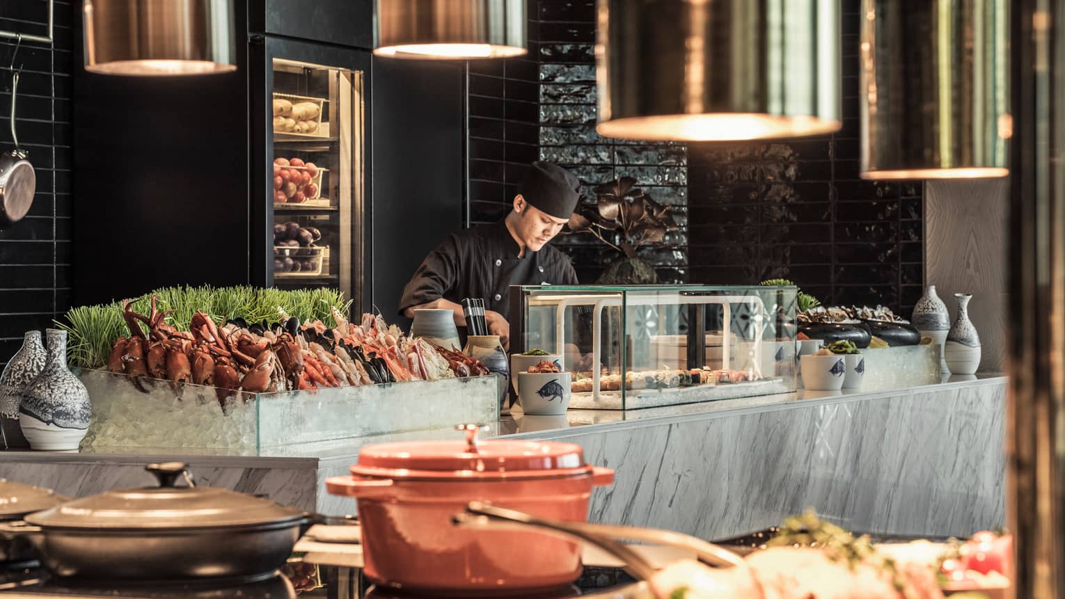 Curate buffet table with server arranging food for guests