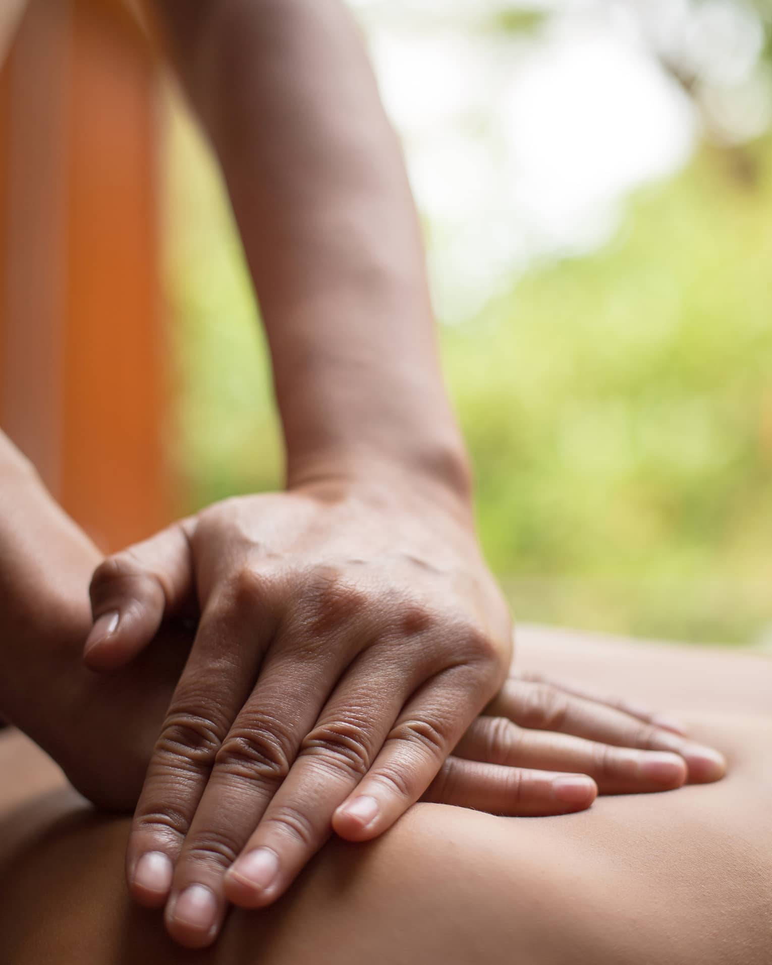 Close up of hands massaging a back