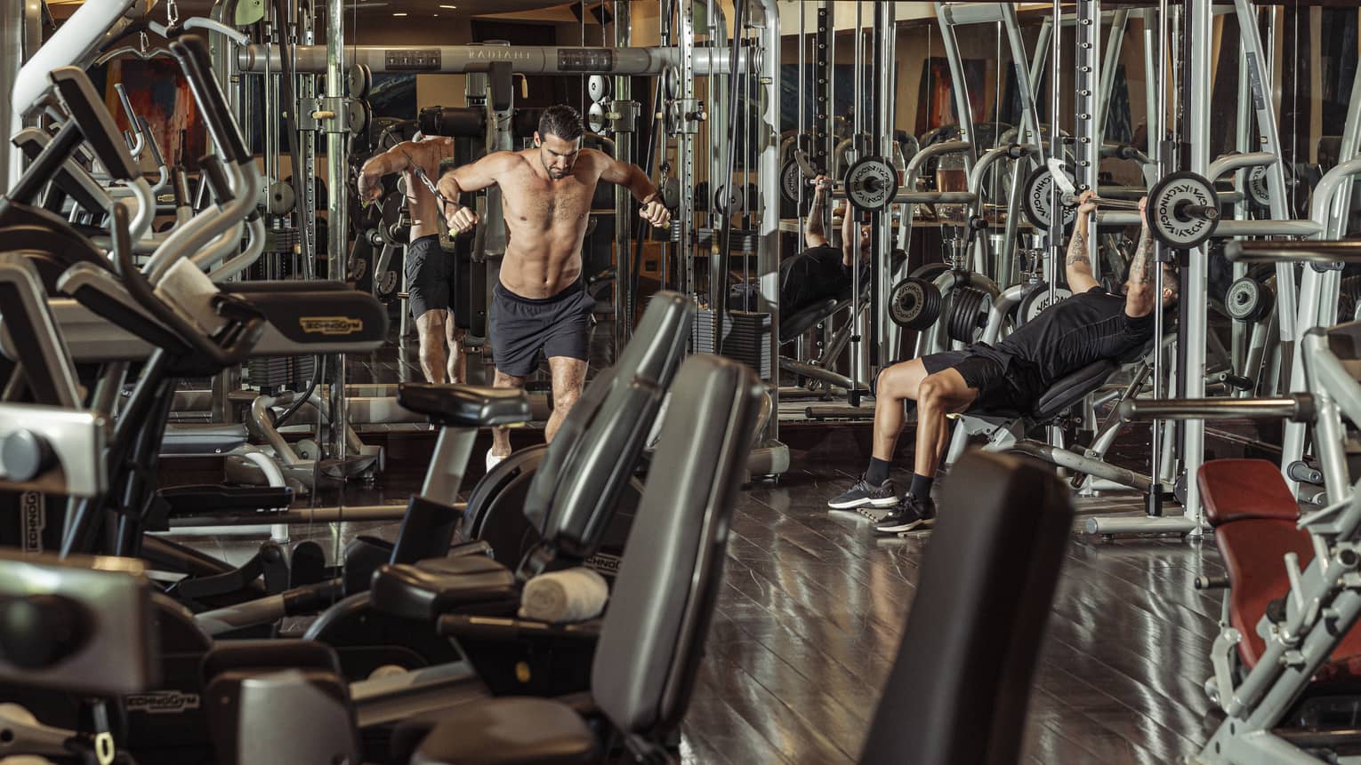 Two people working out on weight equipment in Fitness Centre
