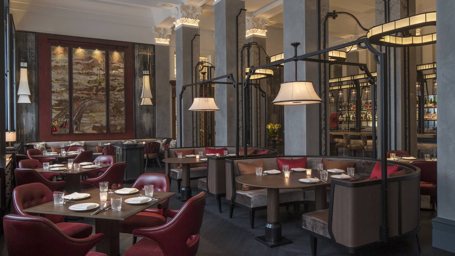 Wide view of Mei Ume dining area, brown tables and booths with red chairs, red and brown accent pillows