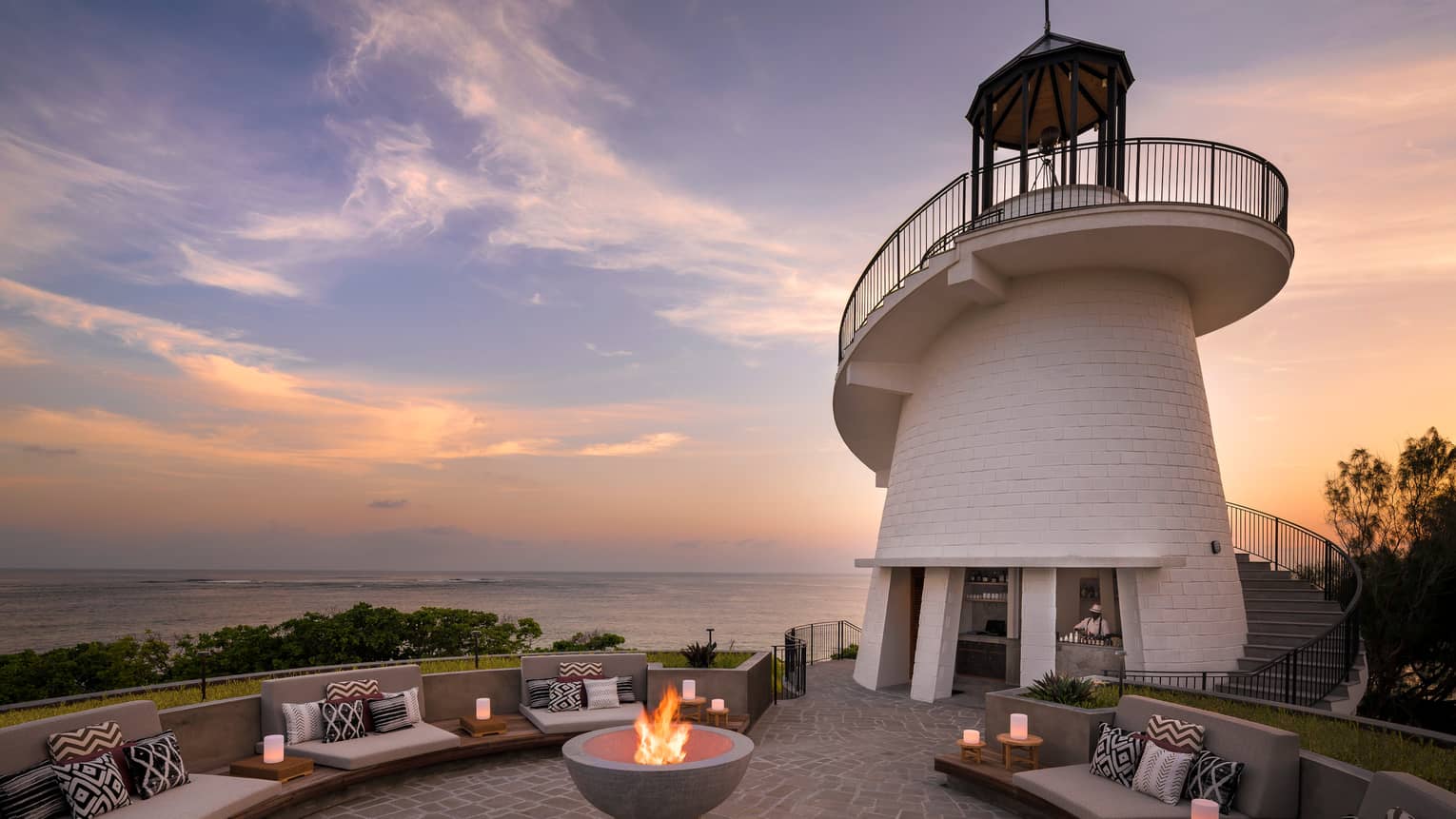 Lighthouse Restaurant illuminated at sunset with fire pit and luminaries