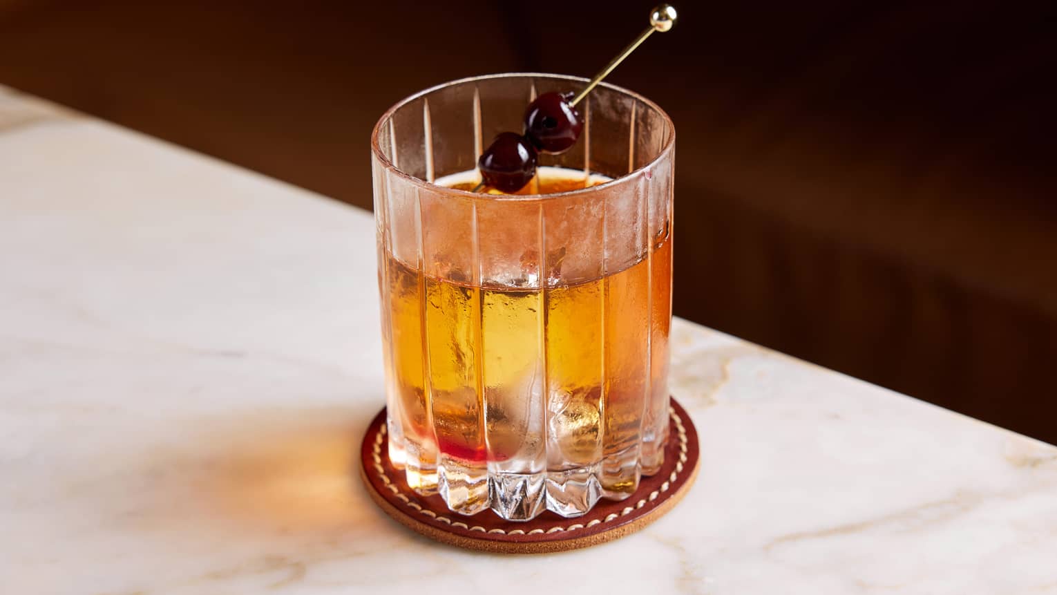 An amber cocktail in a small glass.