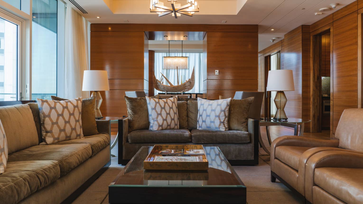 Presidential Suite living room with three sofas and wood-panelled walls, at Four Seasons Hotel Baltimore