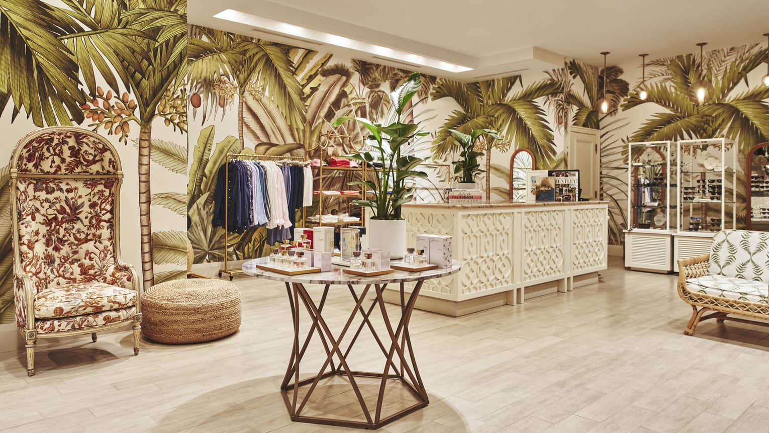A brightly lit store with light wood features and clothes on shelves and hangers.