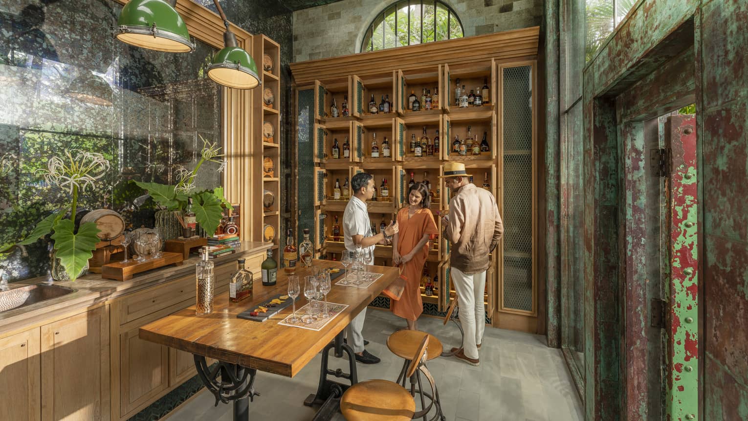Male staff members offers samples to couple at Rum Vault
