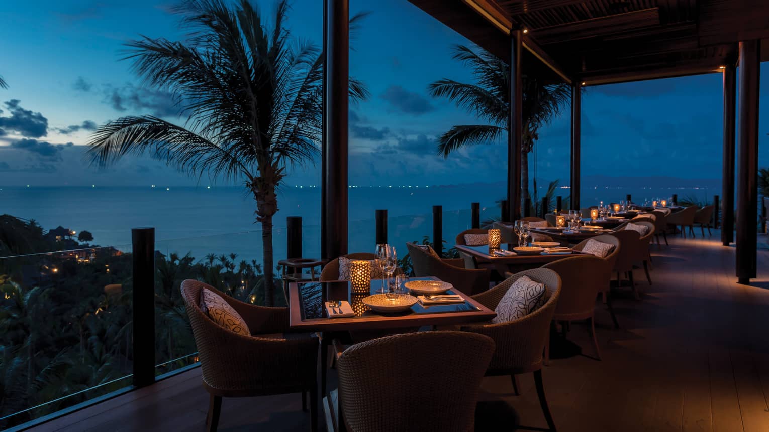Outdoor terrace at Koh Thai Kitchen in Koh Samui, view of palm trees and Gulf of Thailand