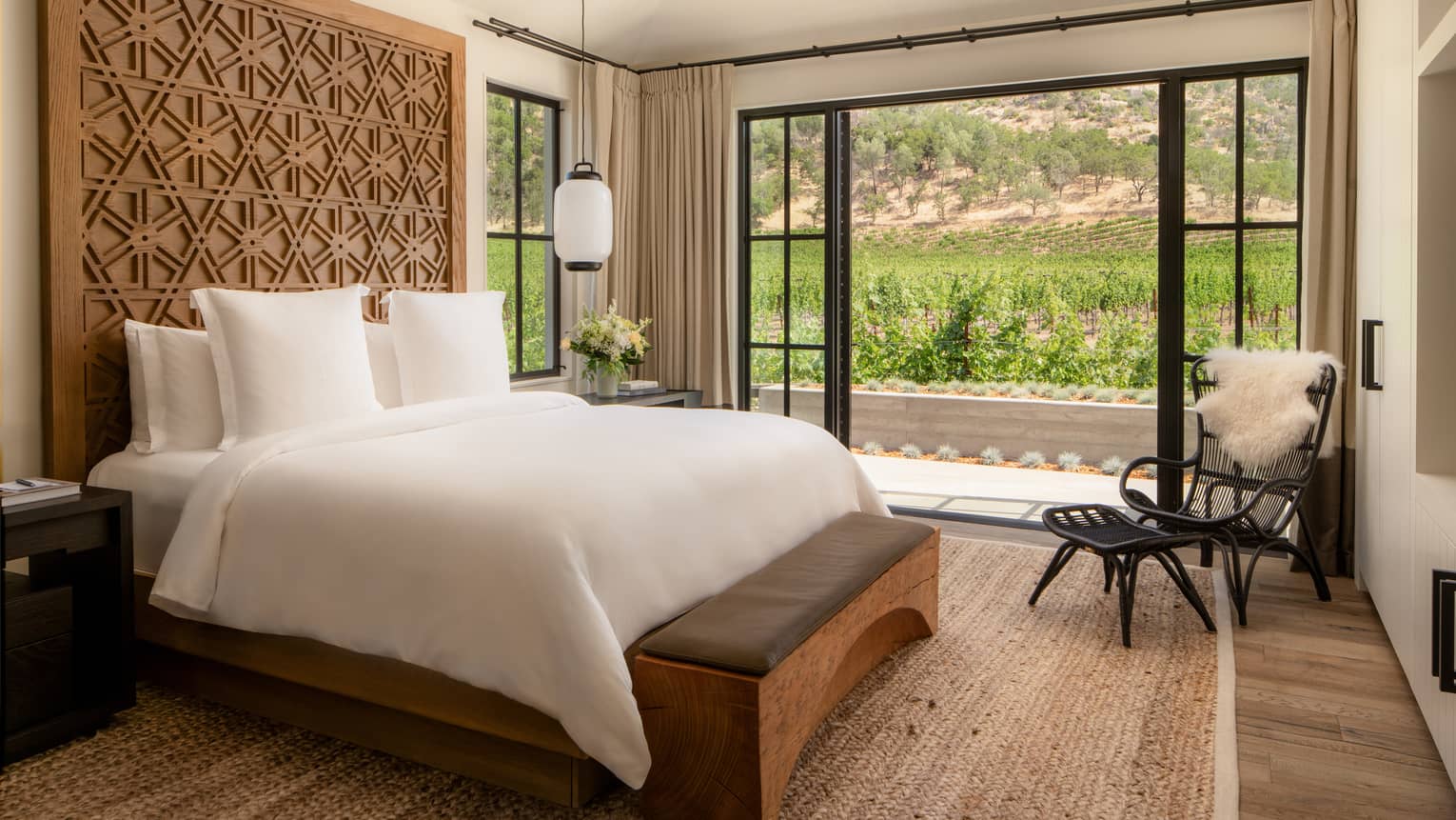 Farmhouse chic, contemporary bedroom with king bed and walk-out terrace with vineyard view