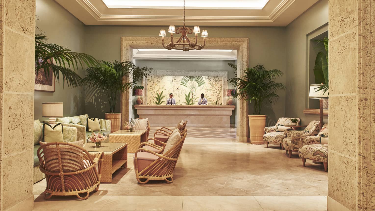 A lobby area with chairs, tables and reception desk.
