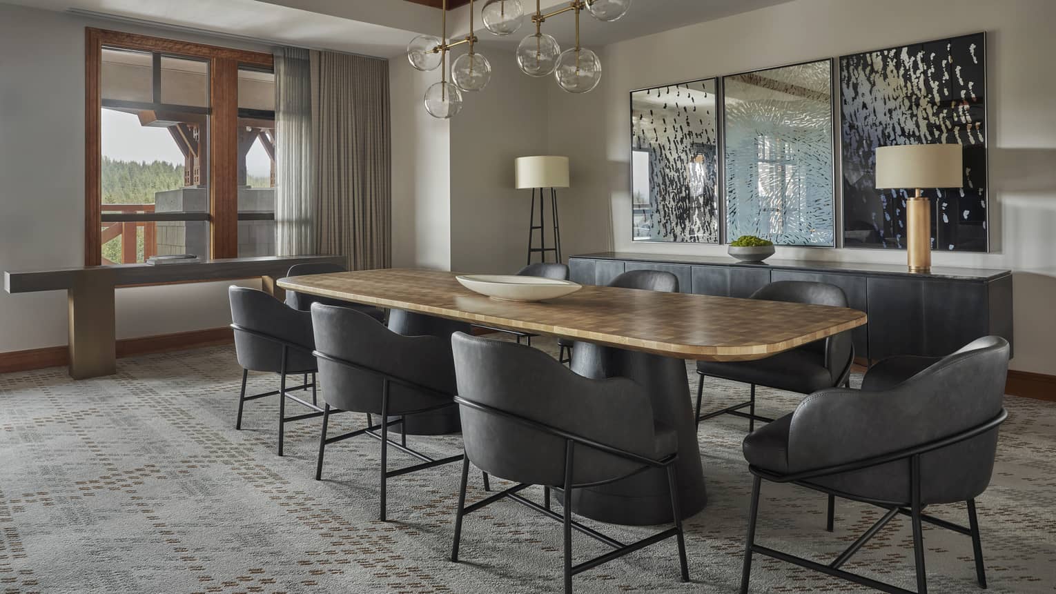 Dining table with eight modern grey seats and a glass pendant lighting fixture