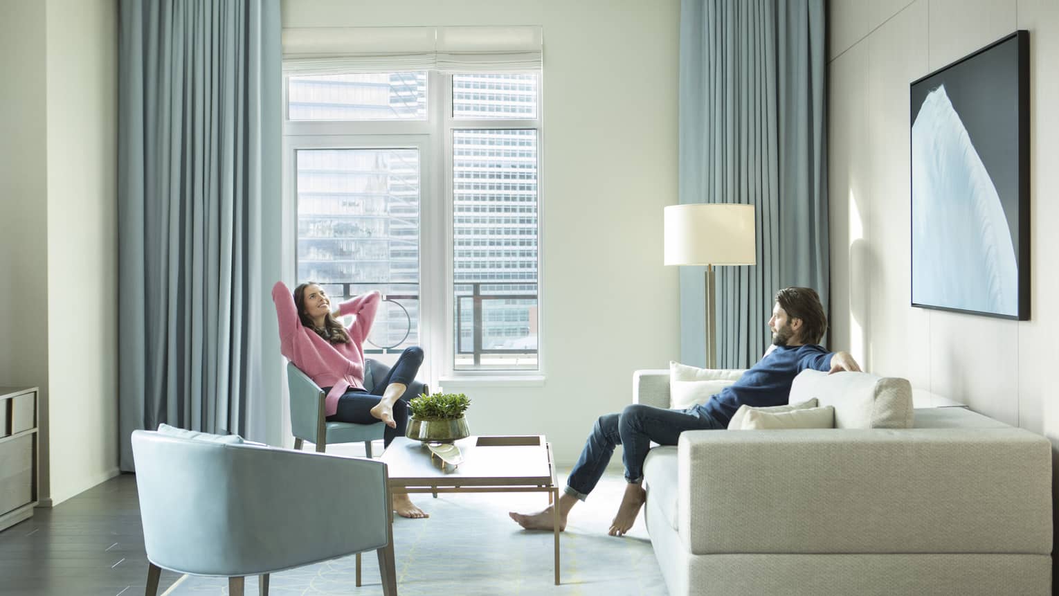 Man and woman relax in guest suite 