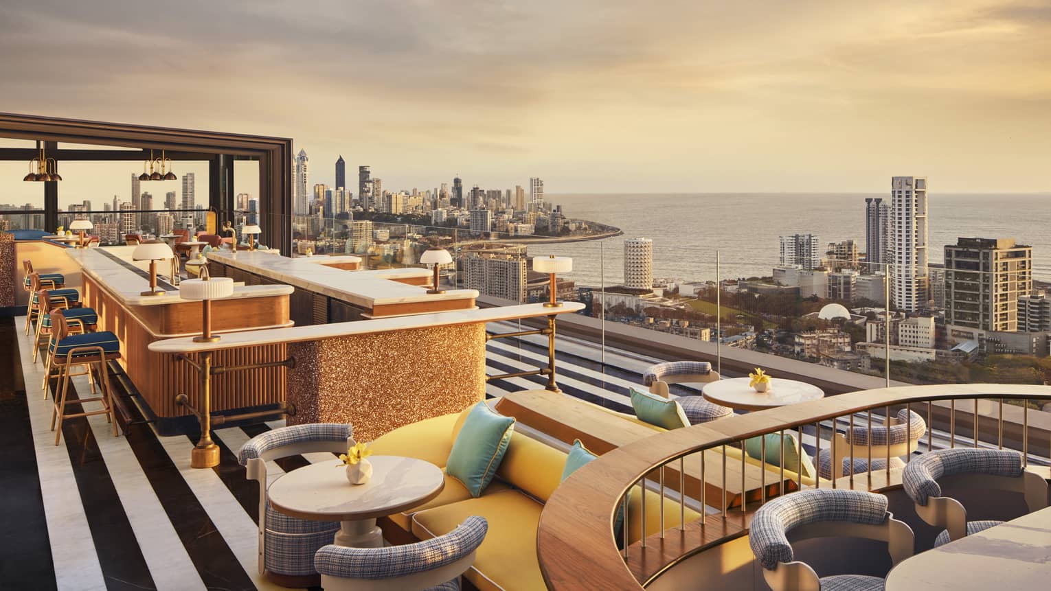 AER rooftop lounge at sunrise with views of Mumbai's skyline