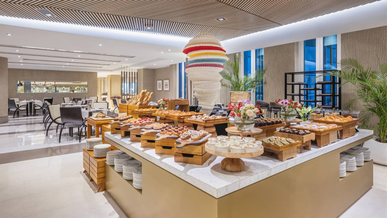 Large breakfast buffet display set in the centre of a restaurant dining room