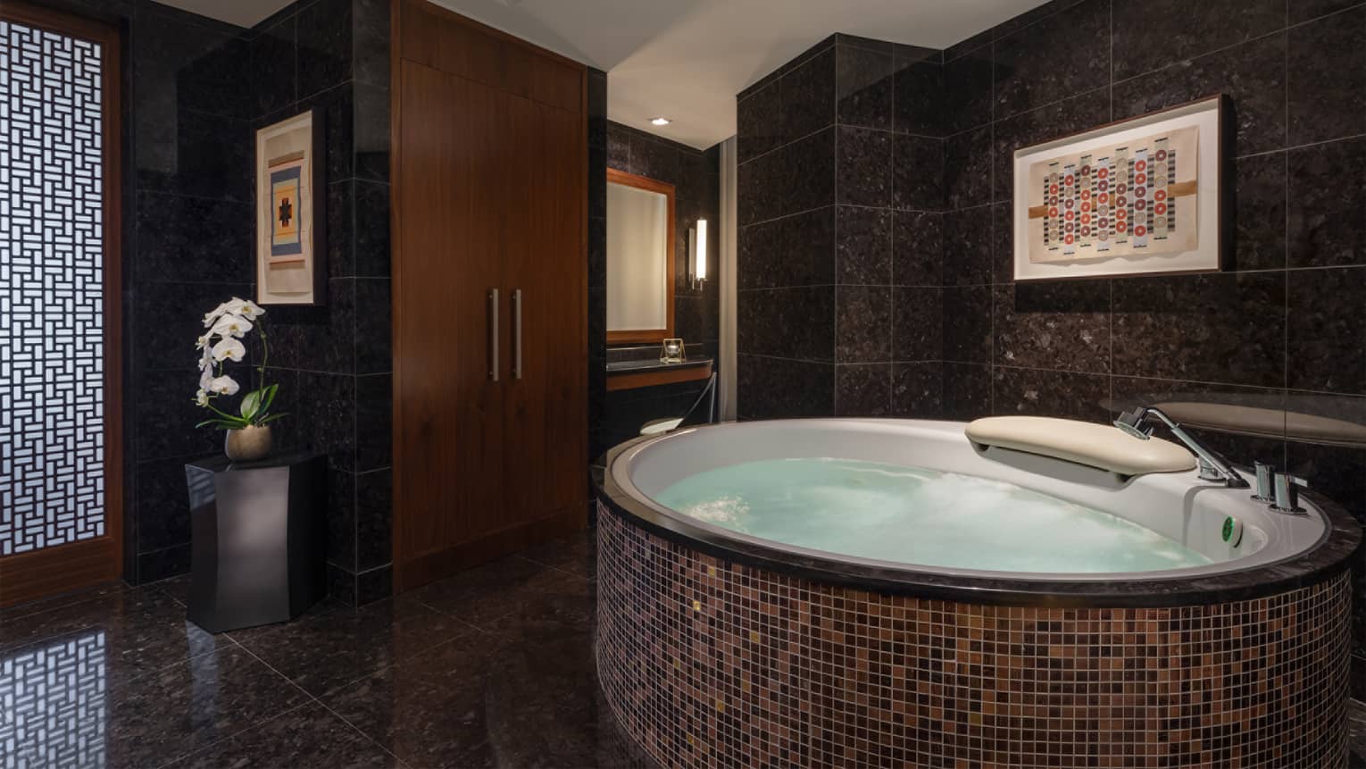 Tiled whirlpool in a black-tile spa room