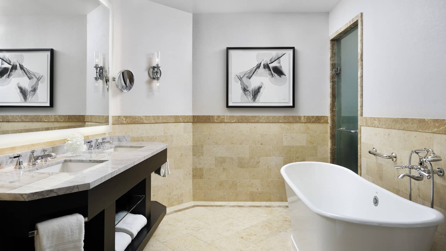 Double marbled vanity with two sinks, full-width mirror, large soaking tub, tiled wall at chair rail