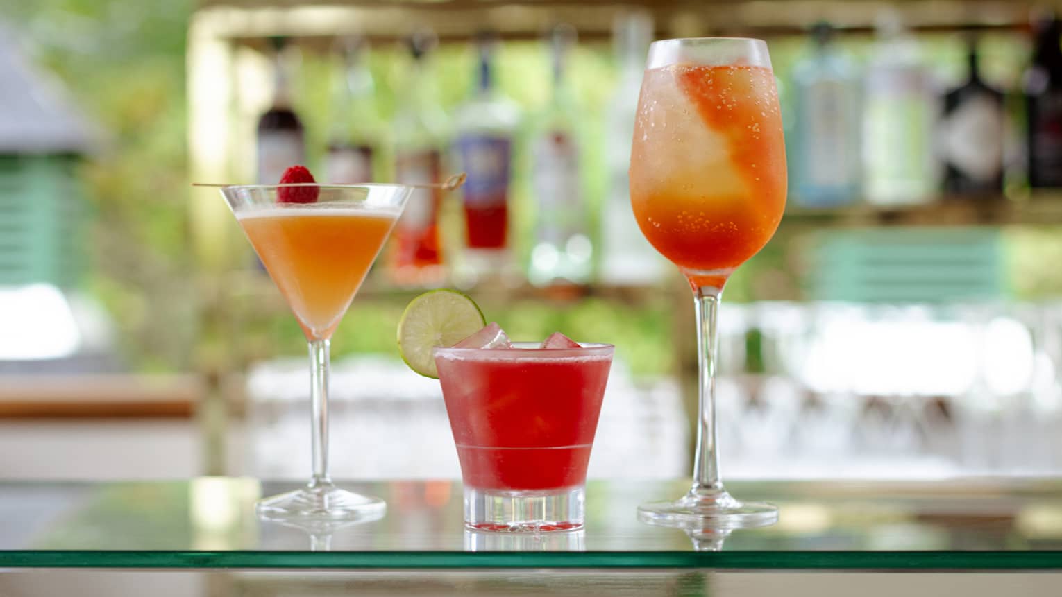 Three cocktails on a bar top