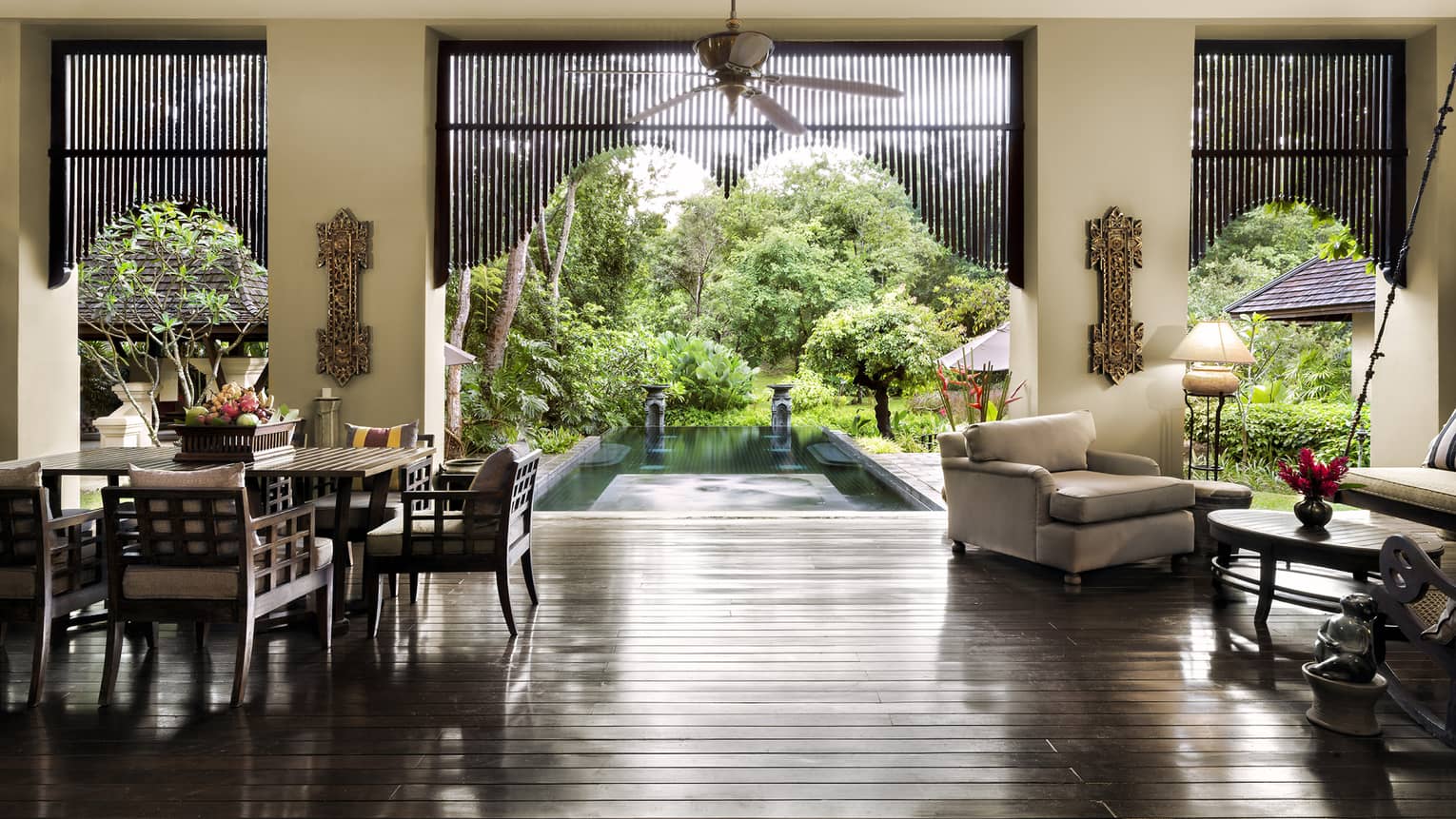 Residence Villa open air living dining room, gleaming wood floors, open wall to pool