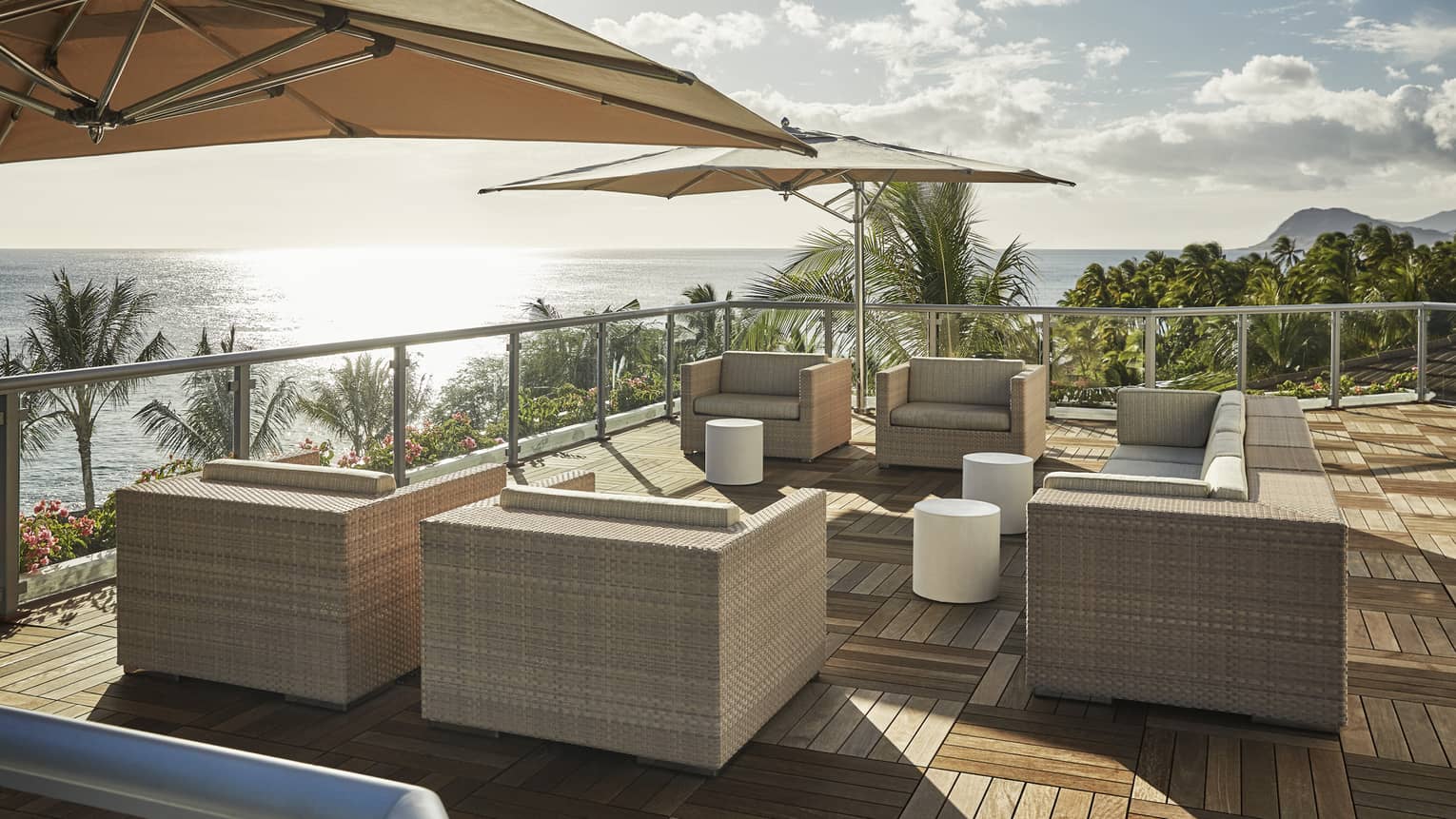 Presidential Suite patio with large wicker chairs, parquet floors, umbrellas, ocean view