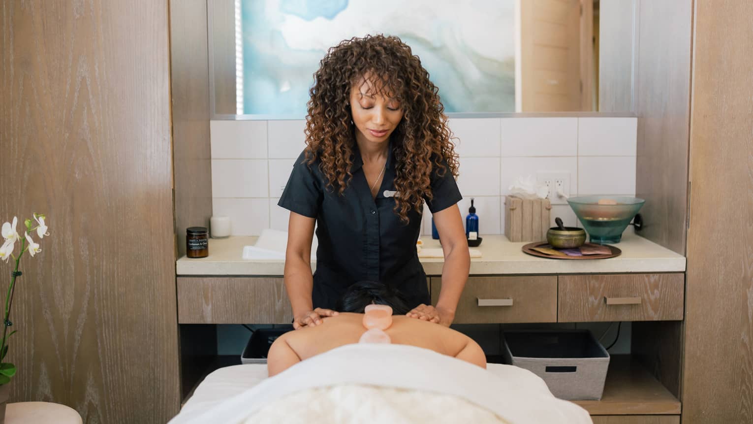 A spa tea member giving a massage.