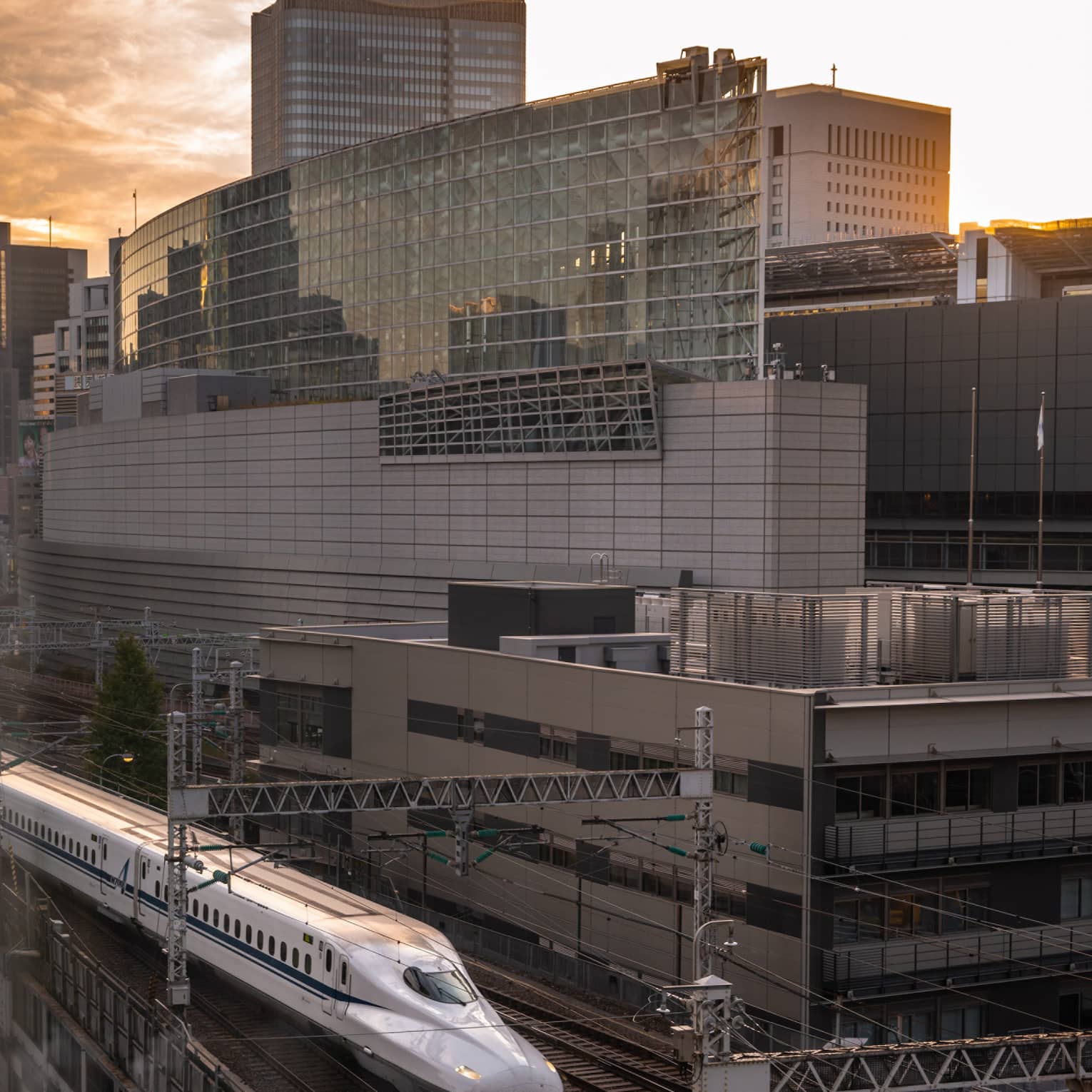 Shinkansen bullet train arrives at the station at sunset
