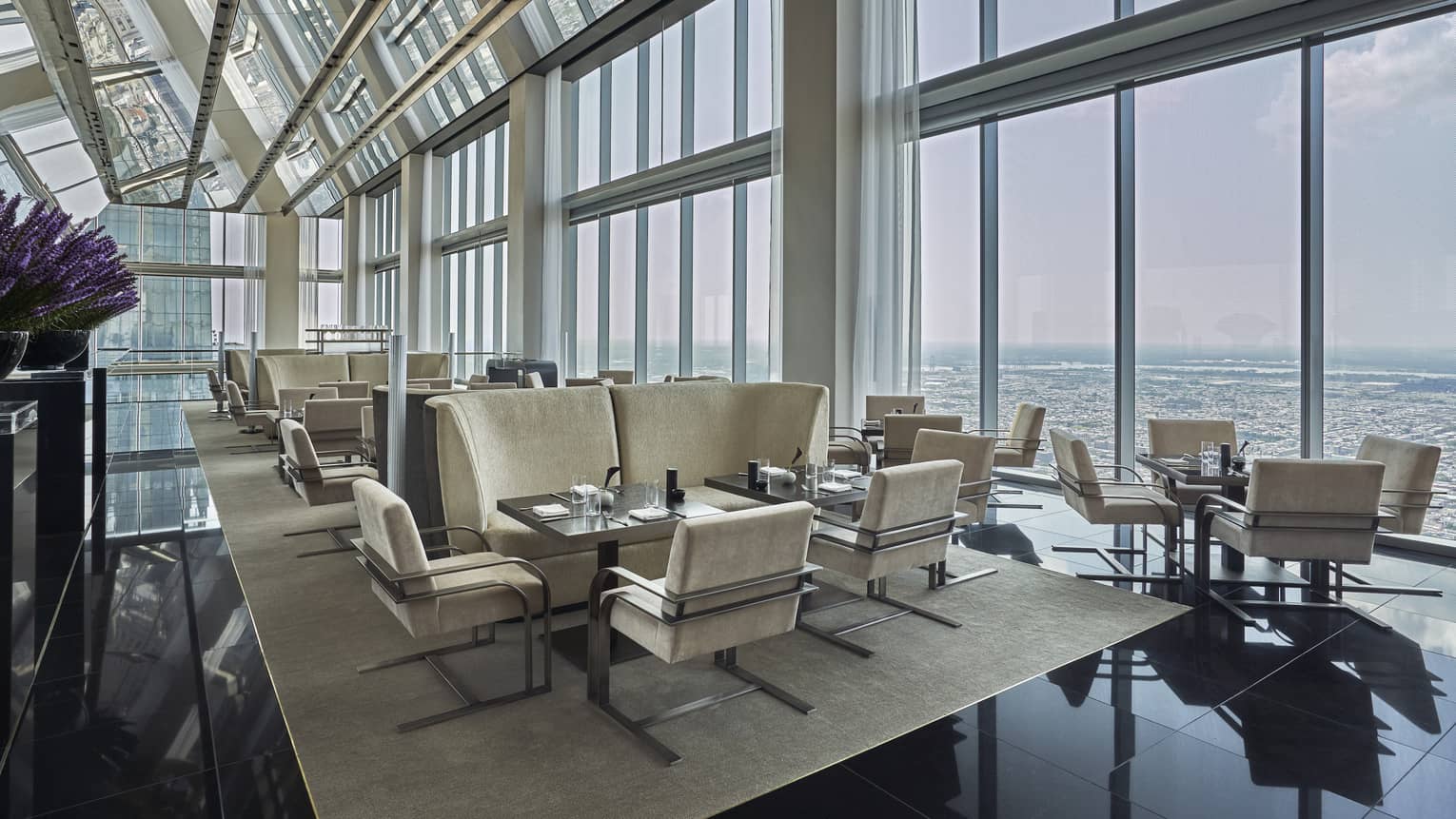A well lit lounge area in the Skyhigh Lounge overlooking the cityscape.