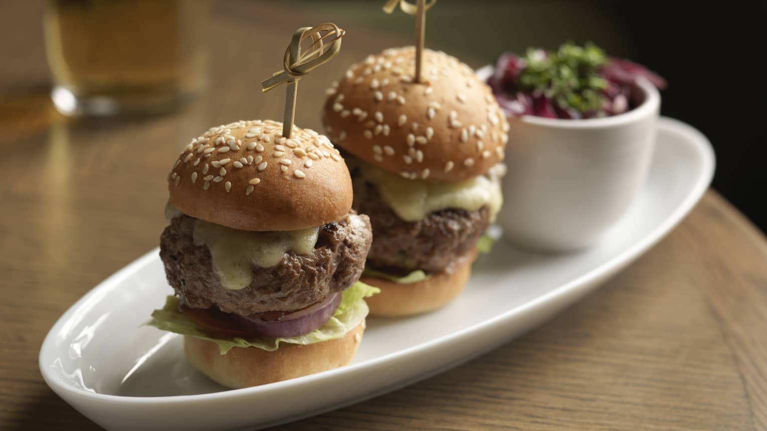 Two Kobe beef sliders served with kimchi slaw and smoked Gouda