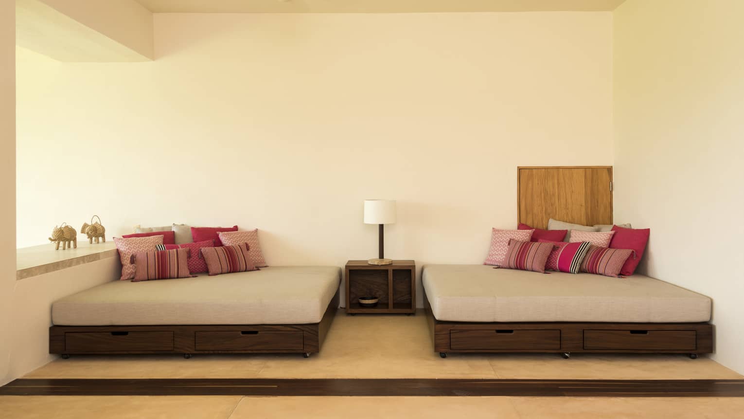 Two indoor daybeds with Mexican artisanal pillows