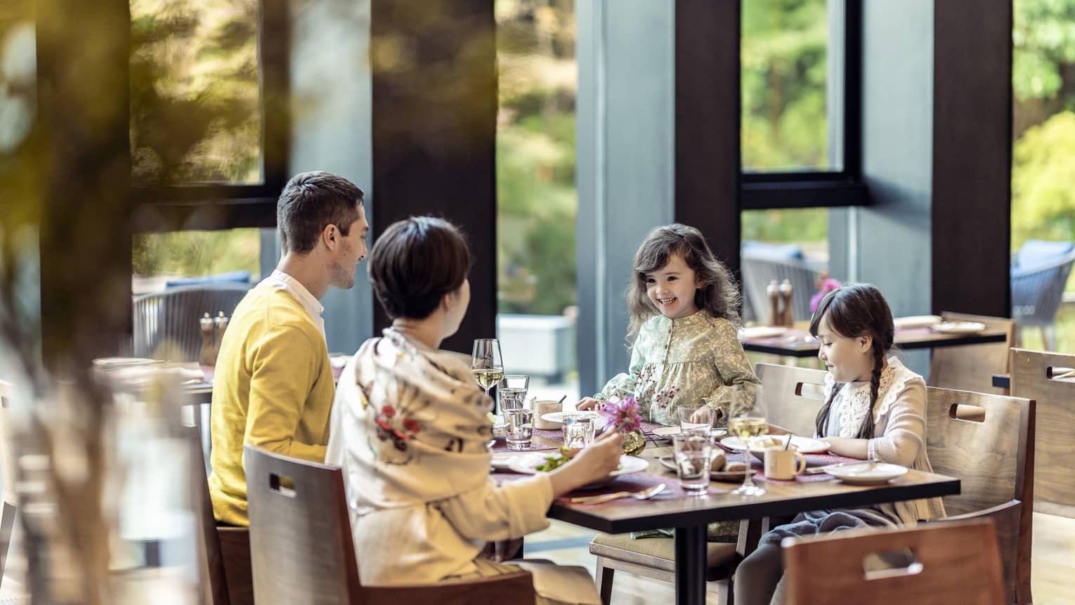 Parents and two young daughters share a meal at Brasserie