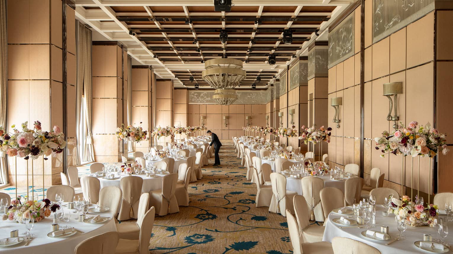 Indoor hotel ballroom set for wedding banquet