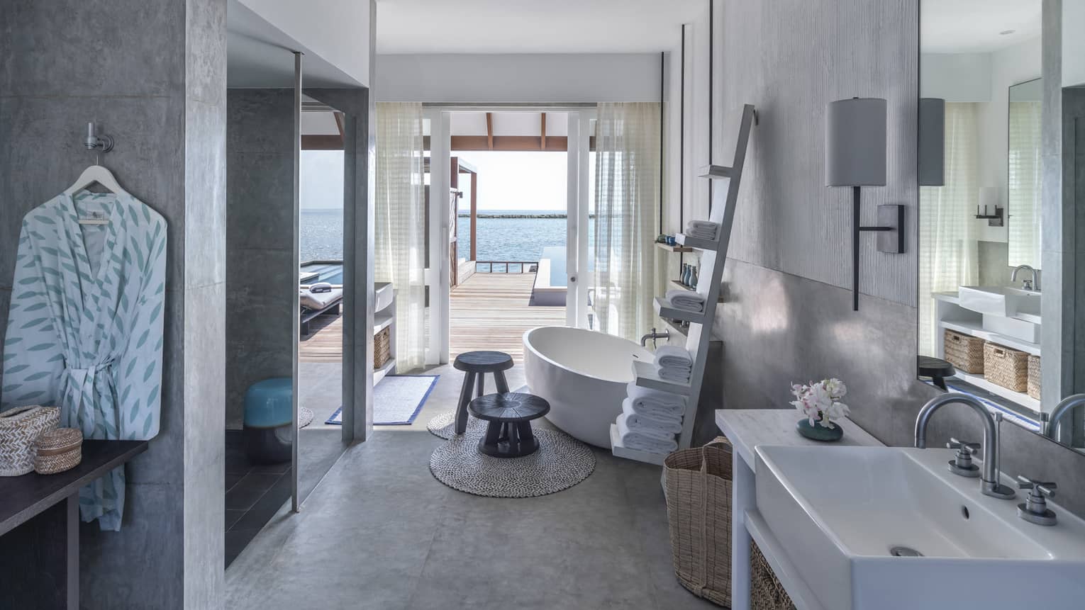 Sunrise Water Villa with Pool bathroom, large soaking tub, towel rack, doorway to deck with pool