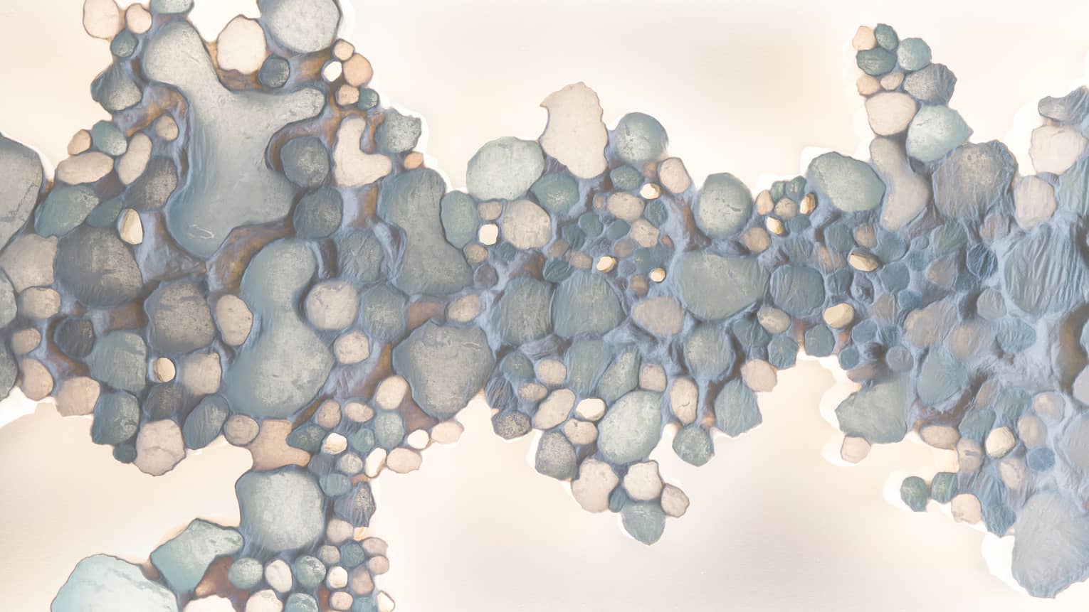 Painting of pebbles in ocean hues at Driftwood Spa
