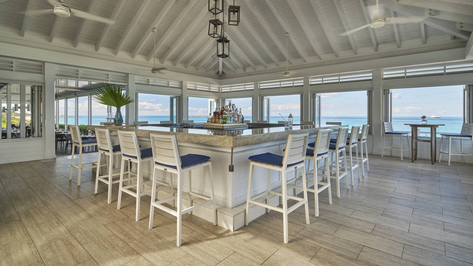 A large open dining area with white features and large windows.