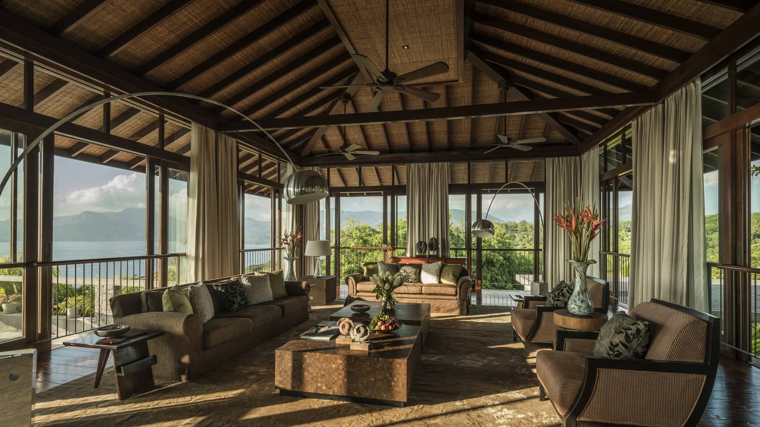 Five-Bedroom Residence Villa open-air living room sofas, armchairs, tables under wood-beam roof