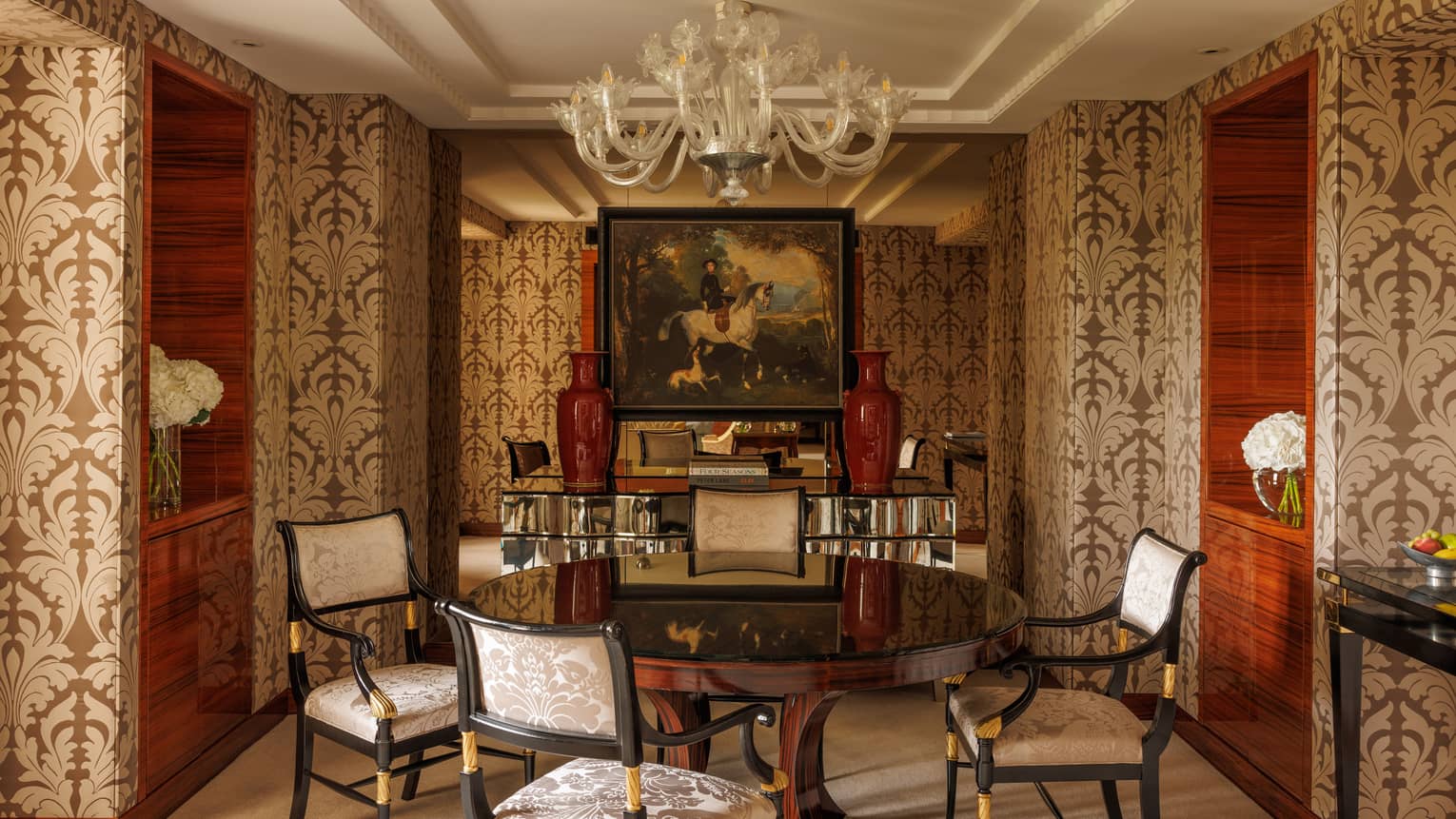 Presidential Suite dining room featuring wall-papered walls, round table and four upholstered chairs, at Four Seasons Hotel London