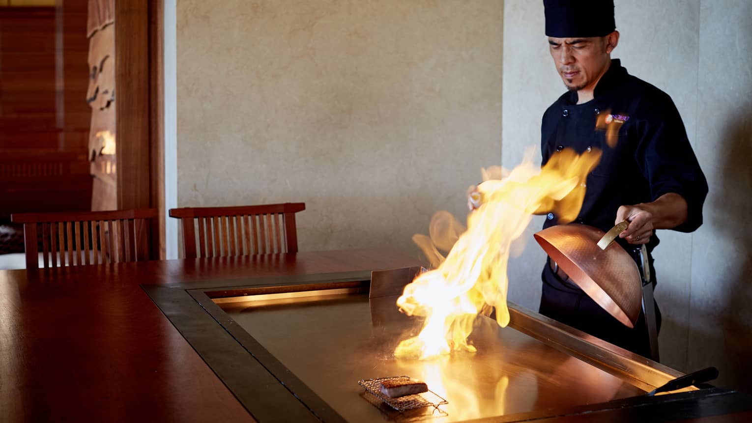 Flames shoot up from grill as NOBU restaurant chef pulls back copper lid