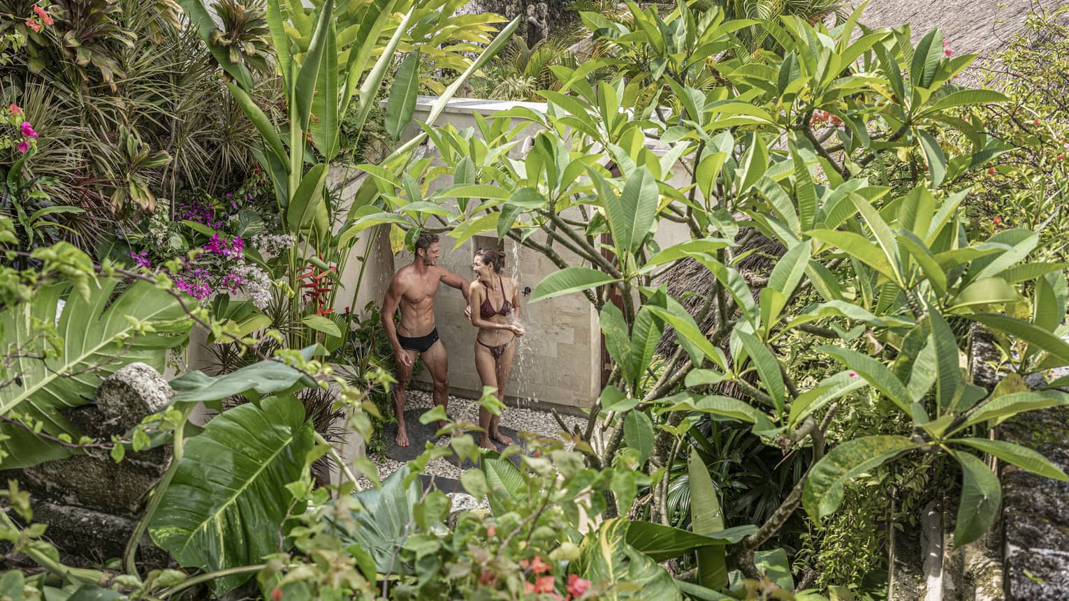 Couple in swimwear at the Healing Village Spa Longevity Garden surrounded by greenery