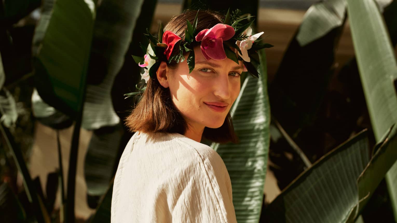 A woman wears Hawaiian flower crown