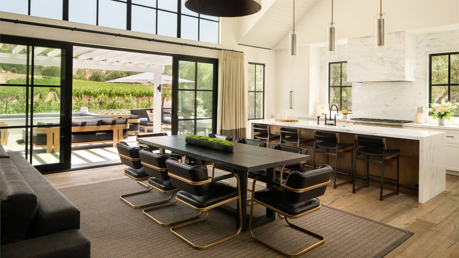 High-ceilinged kitchen and dining room of farmhouse-chic residence