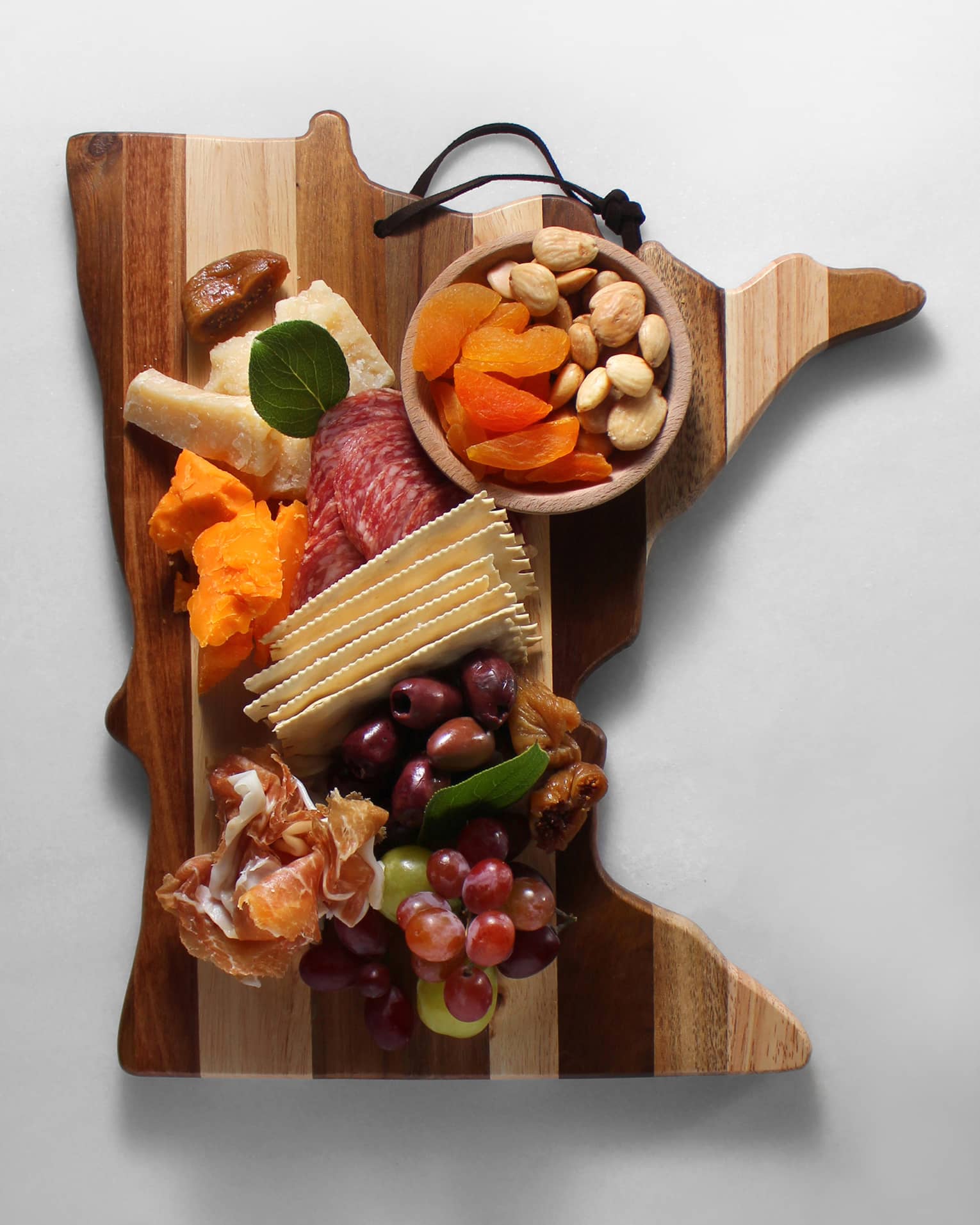 An assortment of meats, crackers and cheese.