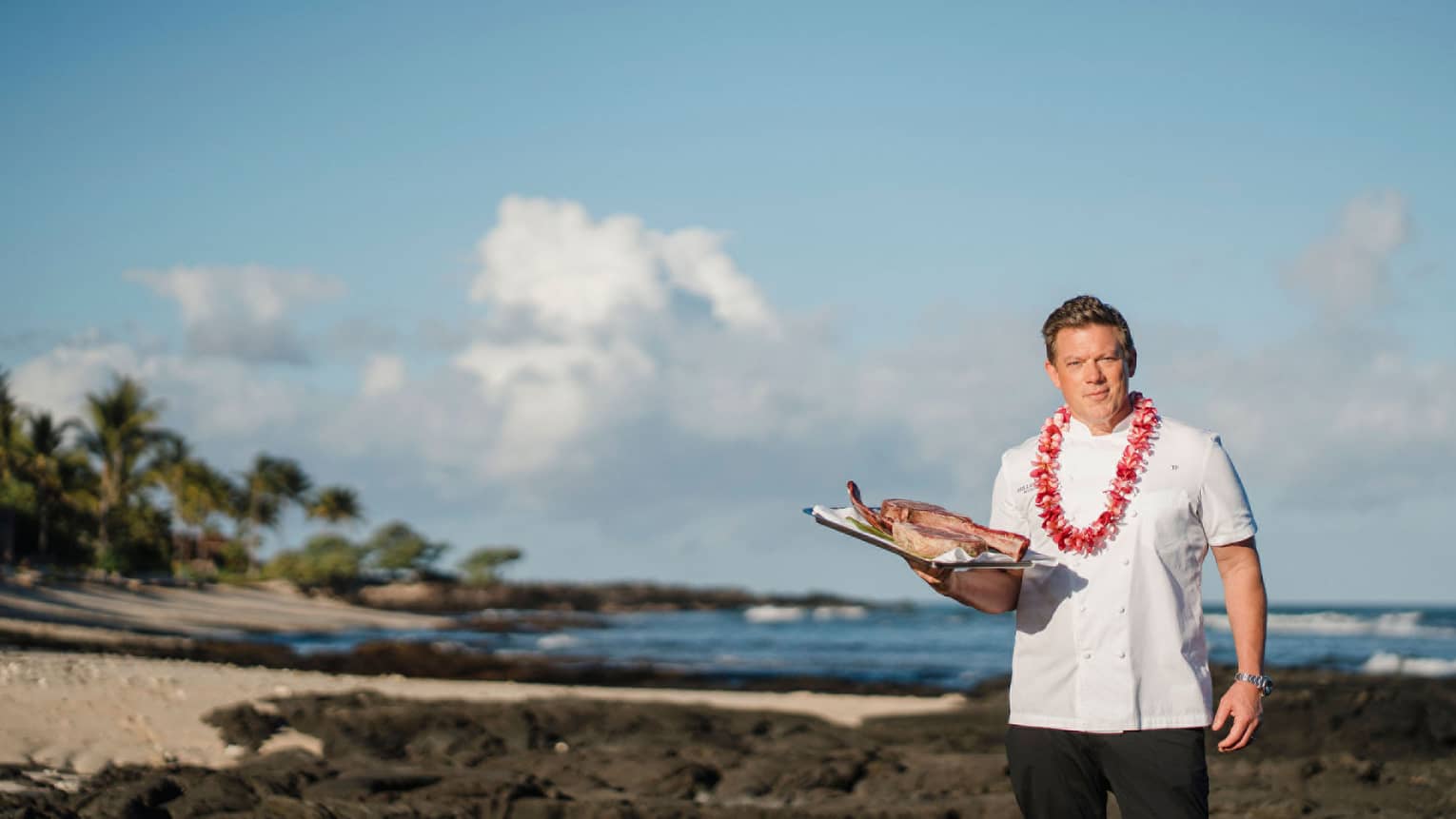 Chef Tyler Florence wears a lei on the beach in Hawaii