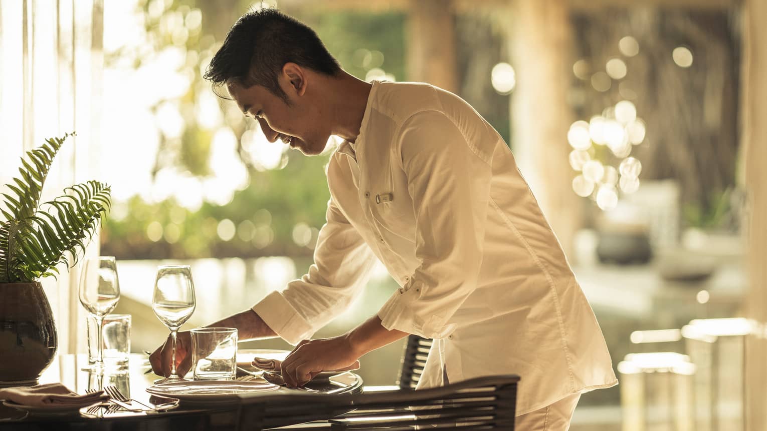 In-villa dining being set up by staff member