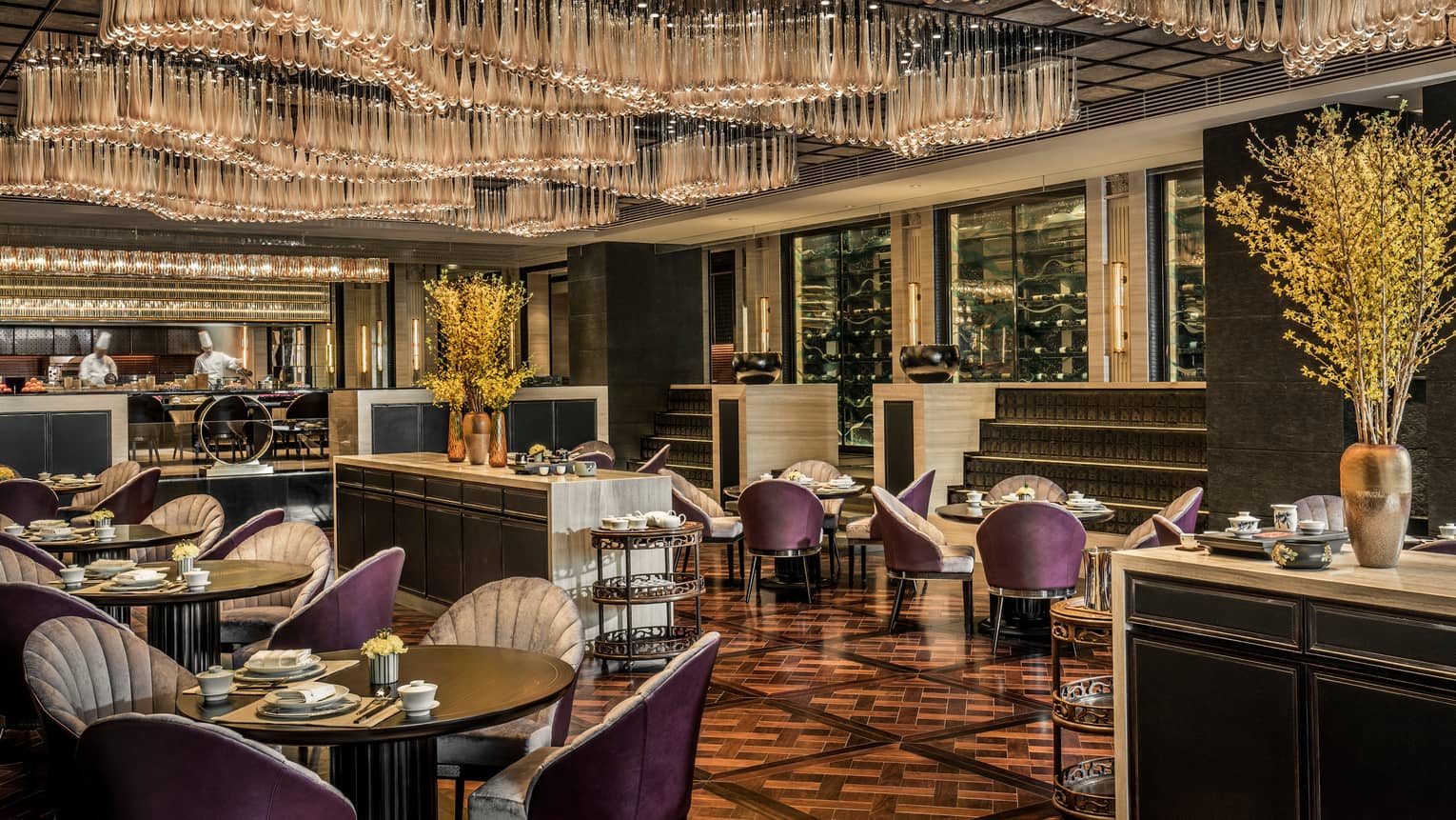 Jin House purple chairs under dining tables under full ceiling with teardrop-shaped crystals
