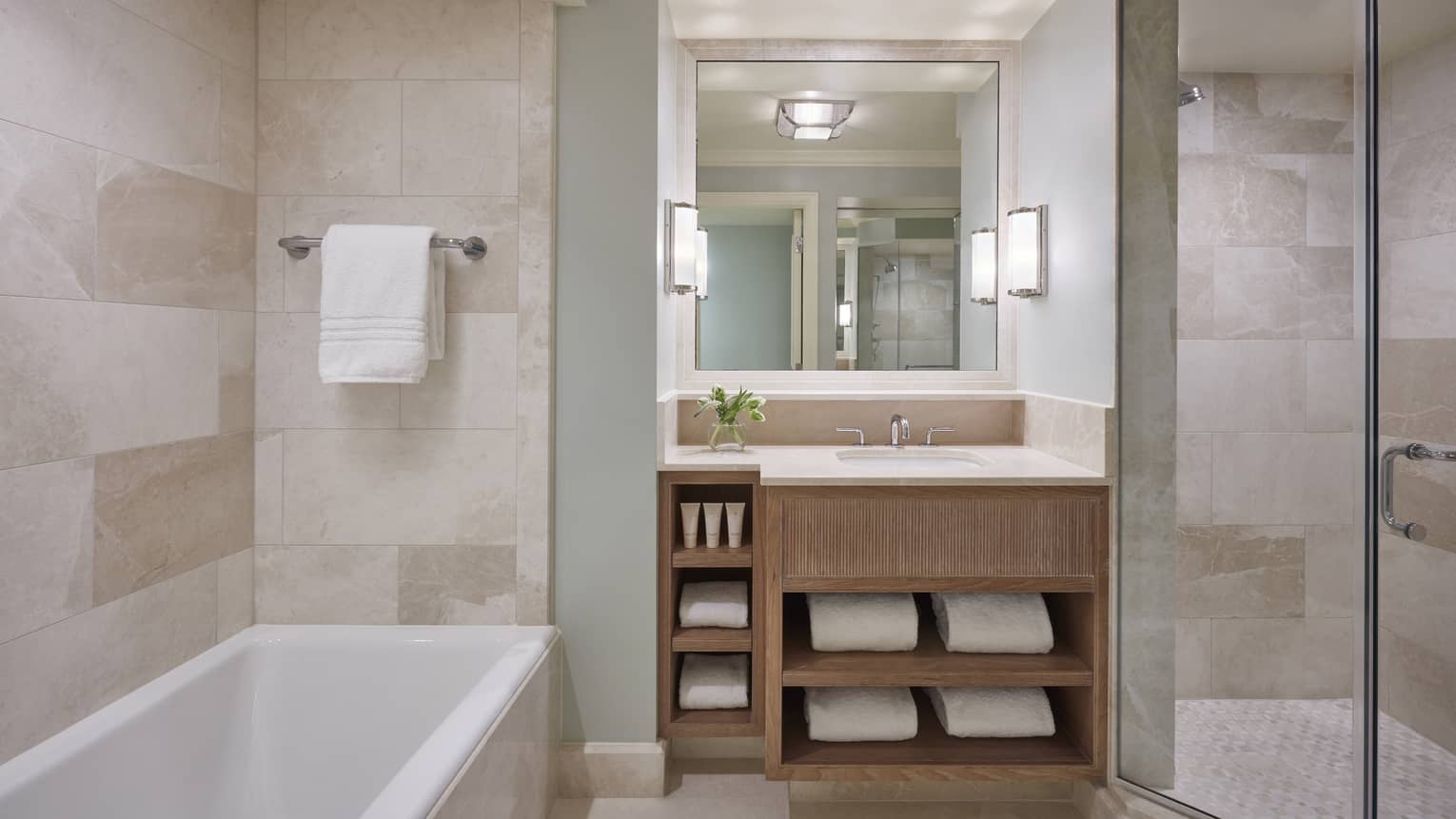 Modern hotel bathroom with a tub and marble walls