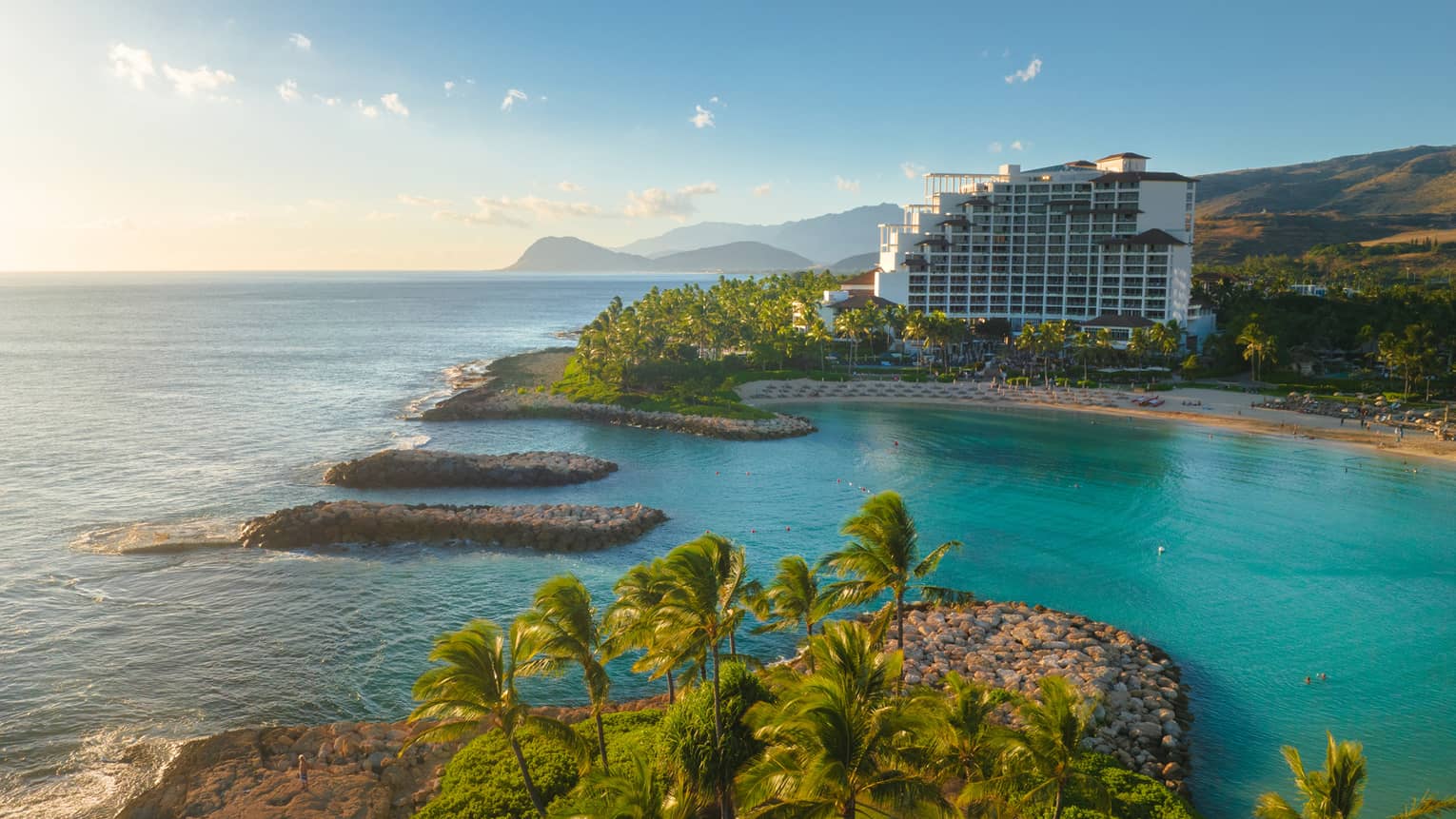 Resort building set on a turquoise lagoon on Hawaiian island
