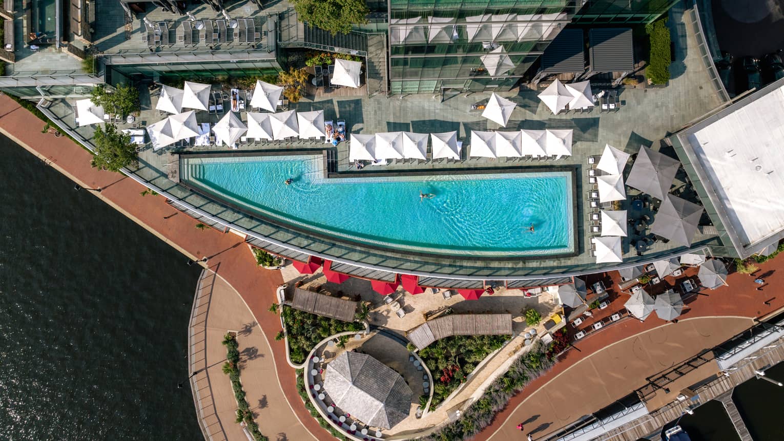 Aerial view of a rooftop pool with cabanas.