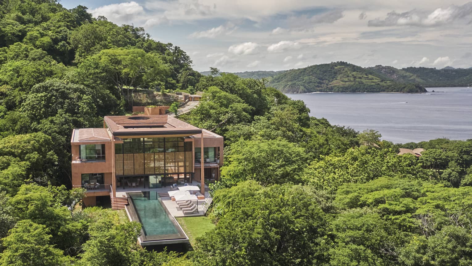 Aerial view of Casa Olas amid greenery and ocean views